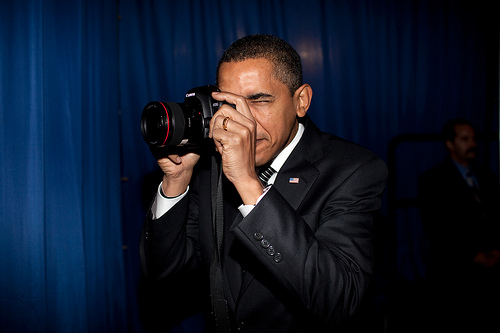 Pres. Obama apparently does not know how to hold a DSLR, but I'm not going to hold it against him. And, as you'll read further in this post, I'm not sure how to attribute this photo. Copyright 2009 by Pete Souza?
