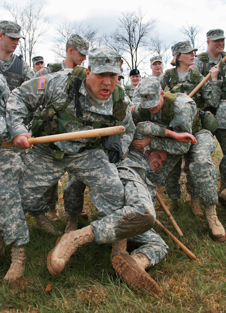 Sgt. Curtis Webb moves forward to reinforce the line formation during the 1140th Military Police Company's riot control training on April 15, 2007. The company, which is a local division of the Missour National Guard, practiced blocks and movement patterns using wooden bats.