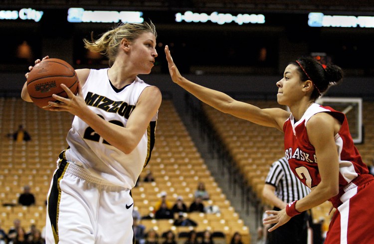 Missouri guard Kassie Drew scans the court to pass the ball away from Nebraska guard Ashly Ford's block during the game's second half on Jan. 20, 2007, at Mizzou Arena. The loss was the Tigers' fifth in conference play.