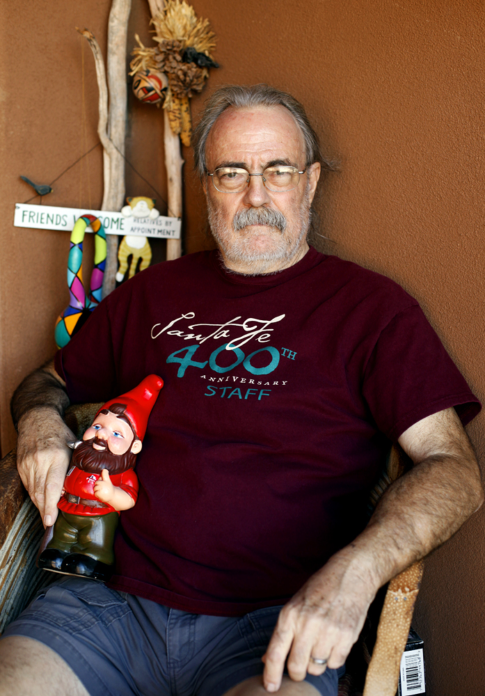 Grant Kalivoda, 67, sits for a portrait in his Santa Fe front porch with Gnorm the Gnome on Tuesday, June 25, 2013.